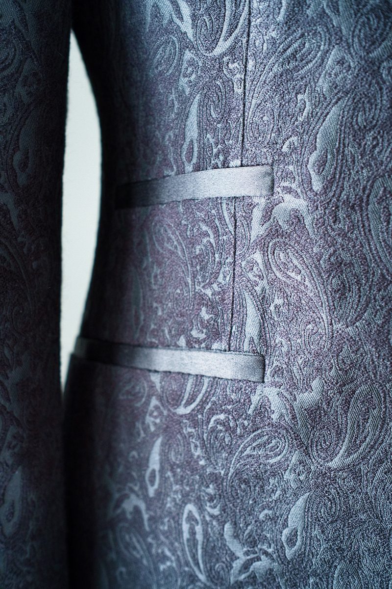 Close up of a paisley jacket lining with jetted pockets